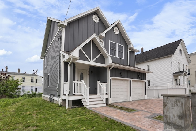864 Baldwin St, Waterbury, CT 06706 - view of front of property with board and batten siding, an attached garage, and decorative driveway