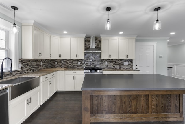 864 Baldwin St, Waterbury, CT 06706 - kitchen featuring wall chimney exhaust hood, a sink, crown molding, tasteful backsplash, and white cabinets