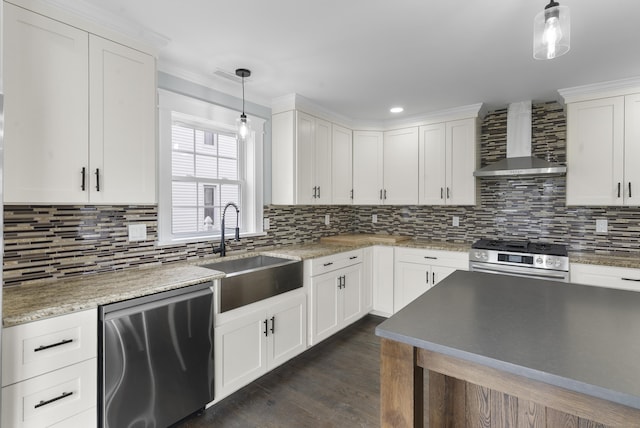 864 Baldwin St, Waterbury, CT 06706 - kitchen featuring stainless steel appliances, wall chimney exhaust hood, a sink, decorative backsplash, and white cabinets