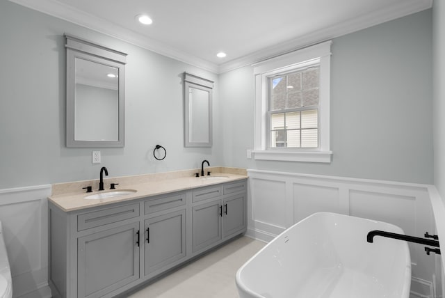 864 Baldwin St, Waterbury, CT 06706 - full bathroom featuring a decorative wall, ornamental molding, wainscoting, a freestanding tub, and double vanity