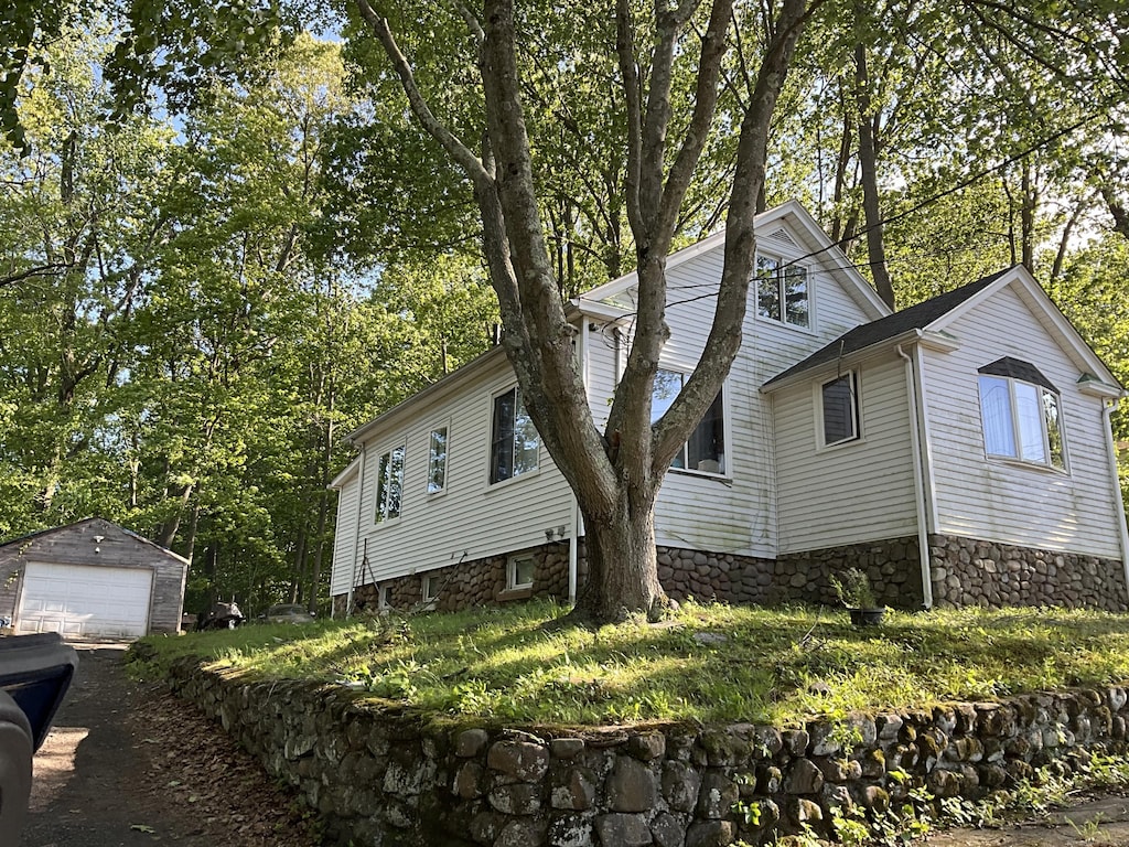 148 Burwell Rd, West Haven, CT 06516 - view of property exterior with a garage, an outdoor structure, and stone siding