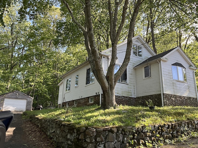 148 Burwell Rd, West Haven, CT 06516 - view of property exterior with a garage, an outdoor structure, and stone siding