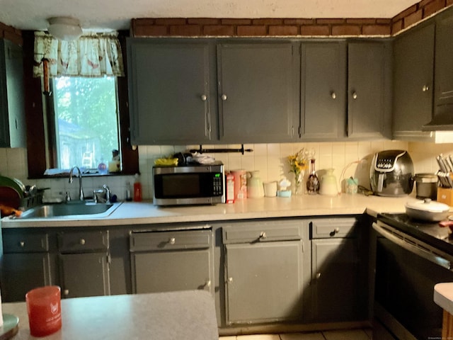 148 Burwell Rd, West Haven, CT 06516 - kitchen featuring stainless steel microwave, black range with electric stovetop, light countertops, and decorative backsplash