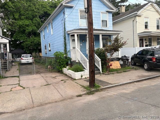 51 Arthur St, New Haven, CT 06519 - view of front of house with covered porch, a gate, and driveway