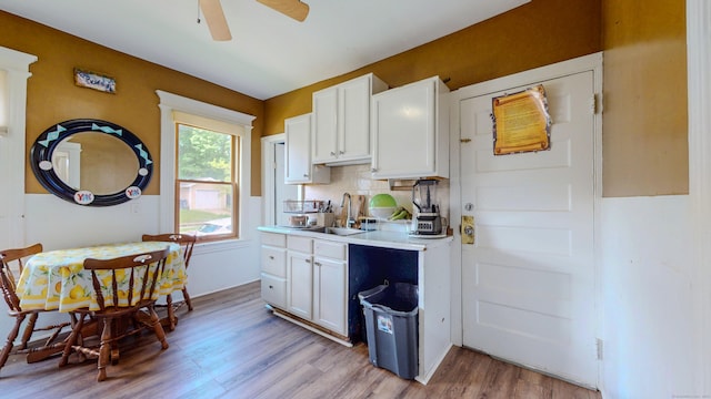 174 Fairview Ave, Bridgeport, CT 06606 - kitchen featuring light countertops, a ceiling fan, white cabinetry, light wood-type flooring, and a sink