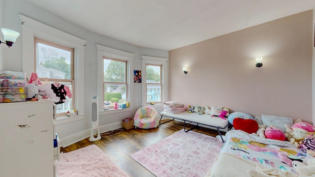 174 Fairview Ave, Bridgeport, CT 06606 - bedroom featuring multiple windows, wood finished floors, and baseboards
