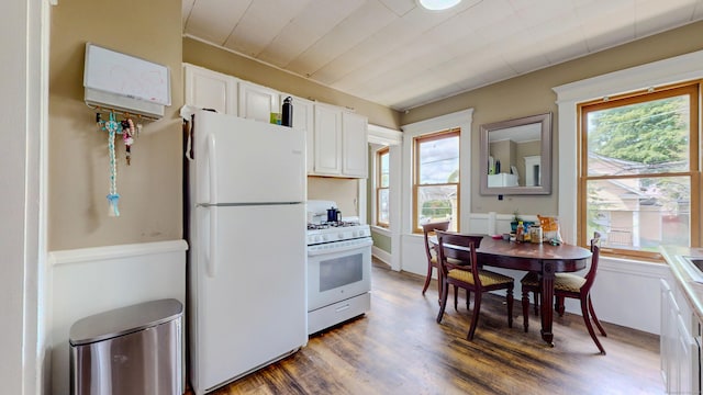 174 Fairview Ave, Bridgeport, CT 06606 - kitchen with white appliances, dark wood-type flooring, and white cabinetry
