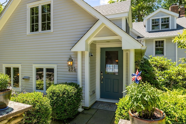 424 E Wakefield Blvd, Winchester, CT 06098 - view of exterior entry with a shingled roof and a chimney