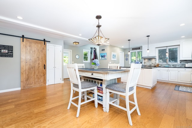 424 E Wakefield Blvd, Winchester, CT 06098 - dining space featuring a barn door, light wood finished floors, and recessed lighting