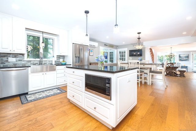 424 E Wakefield Blvd, Winchester, CT 06098 - kitchen with appliances with stainless steel finishes, a chandelier, dark countertops, a sink, and a wall mounted AC