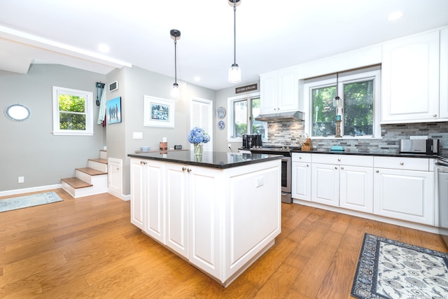 424 E Wakefield Blvd, Winchester, CT 06098 - kitchen featuring under cabinet range hood, electric stove, dark countertops, a kitchen island, and backsplash