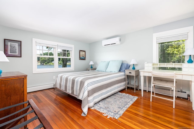 424 E Wakefield Blvd, Winchester, CT 06098 - bedroom with a wall unit AC, a baseboard radiator, multiple windows, and wood finished floors