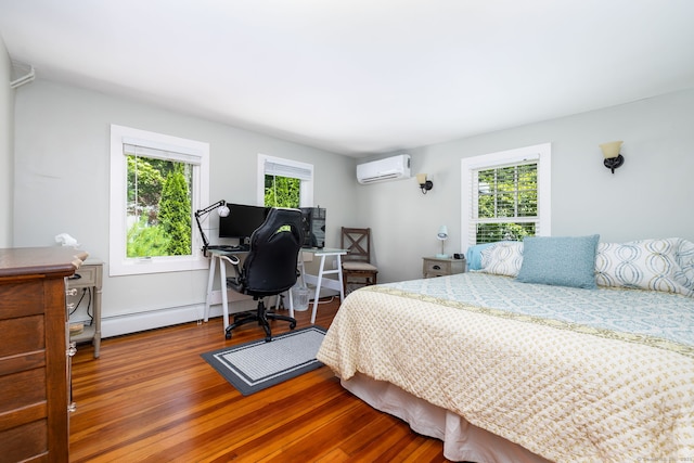 424 E Wakefield Blvd, Winchester, CT 06098 - bedroom with wood finished floors, a wall mounted air conditioner, an office area, and baseboard heating