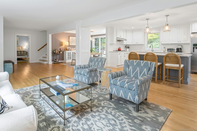 6 Queens Ln, Darien, CT 06820 - living area with light wood finished floors, plenty of natural light, stairway, and baseboards