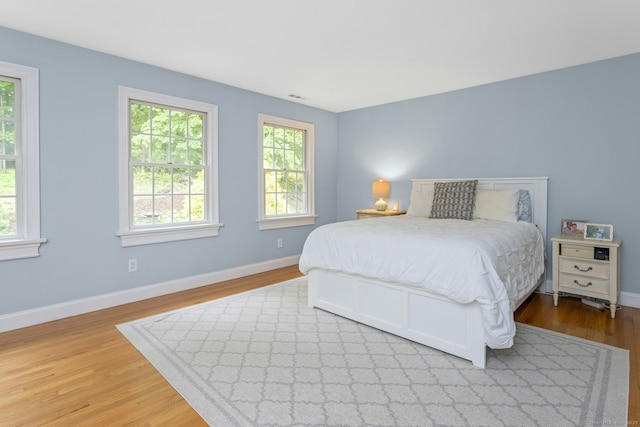 6 Queens Ln, Darien, CT 06820 - bedroom featuring wood finished floors, multiple windows, and baseboards