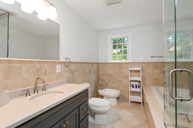 6 Queens Ln, Darien, CT 06820 - bathroom with tile walls, tile patterned floors, a bidet, toilet, and tiled tub