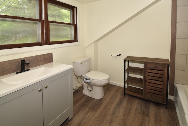 17 Spruce St, Vernon, CT 06066 - full bathroom featuring wood finished floors, toilet, a tub to relax in, vanity, and baseboards