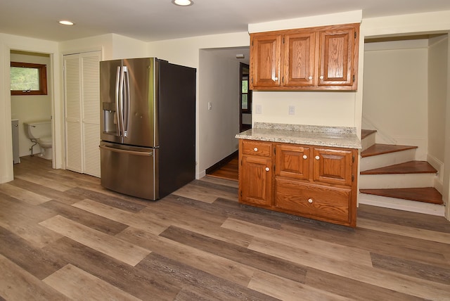 17 Spruce St, Vernon, CT 06066 - kitchen with stainless steel refrigerator with ice dispenser, recessed lighting, dark wood-style floors, brown cabinets, and baseboards