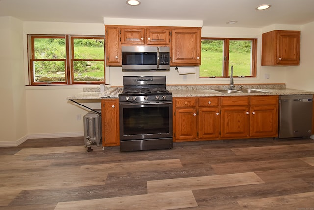 17 Spruce St, Vernon, CT 06066 - kitchen with stainless steel appliances, a sink, radiator heating unit, recessed lighting, and brown cabinets
