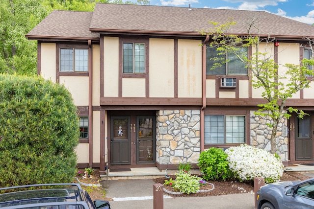202 Foxwood Ln Unit 202, Milford, CT 06461 - view of front of property with stucco siding, stone siding, and roof with shingles