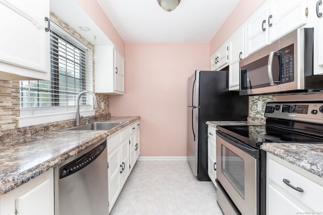 202 Foxwood Ln Unit 202, Milford, CT 06461 - kitchen featuring appliances with stainless steel finishes, a sink, baseboards, and white cabinetry