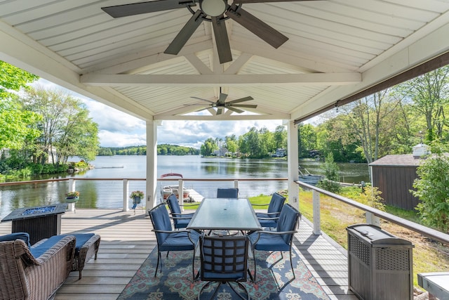 72 Lake View Dr, Woodstock, CT 06281 - wooden terrace featuring ceiling fan, a water view, outdoor dining area, and view of scattered trees