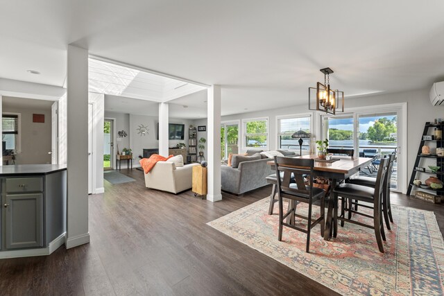 72 Lake View Dr, Woodstock, CT 06281 - dining space featuring dark wood-style flooring, an AC wall unit, baseboards, and a chandelier