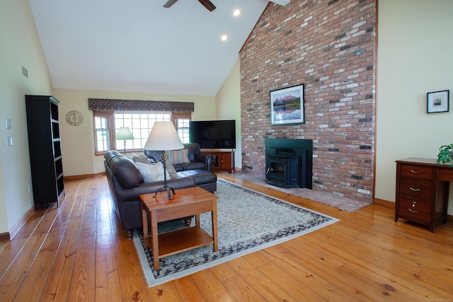 41 Blue Ridge Dr, Simsbury, CT 06089 - living area with high vaulted ceiling, a wood stove, light wood-style flooring, and ceiling fan