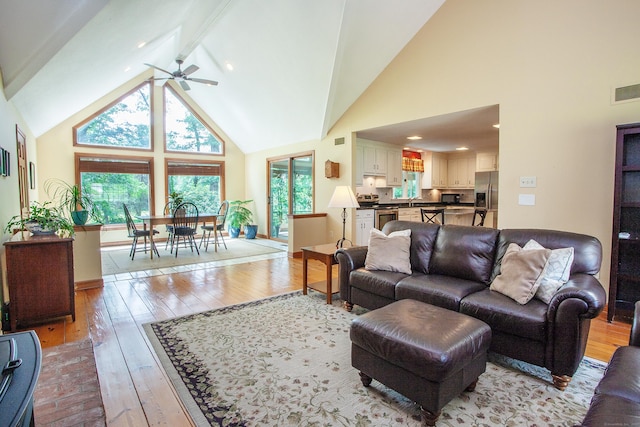 41 Blue Ridge Dr, Simsbury, CT 06089 - living area with high vaulted ceiling, light wood-style floors, ceiling fan, and beam ceiling