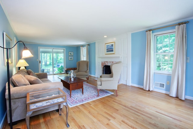 41 Blue Ridge Dr, Simsbury, CT 06089 - living room featuring light wood finished floors, crown molding, and a fireplace