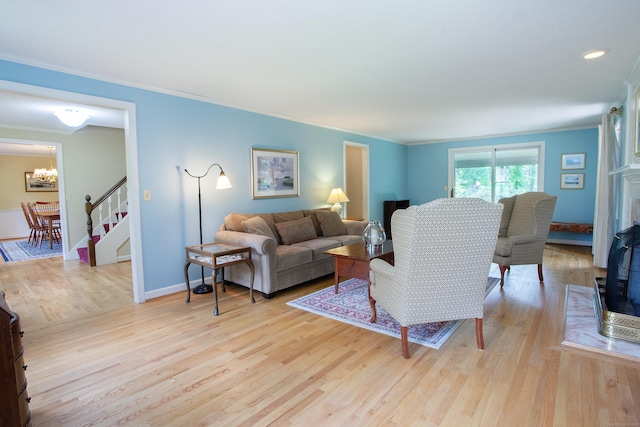 41 Blue Ridge Dr, Simsbury, CT 06089 - living room with ornamental molding, a chandelier, light wood-style flooring, and stairs