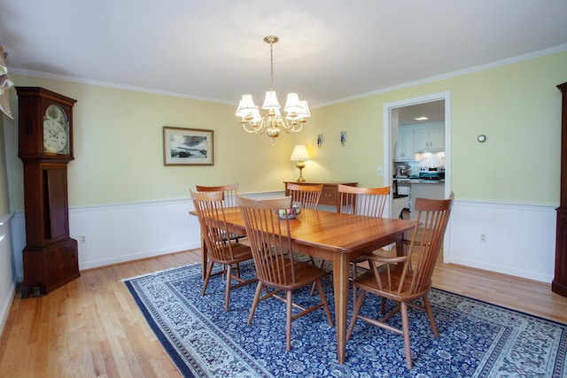 41 Blue Ridge Dr, Simsbury, CT 06089 - dining space with light wood-type flooring, a chandelier, and crown molding