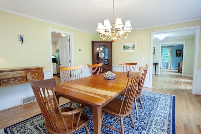 41 Blue Ridge Dr, Simsbury, CT 06089 - dining area featuring ornamental molding, light wood-type flooring, and a chandelier