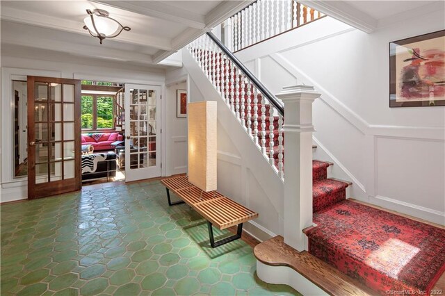 15 Tunxis Trl, Redding, CT 06896 - staircase featuring french doors, a decorative wall, beam ceiling, and wainscoting