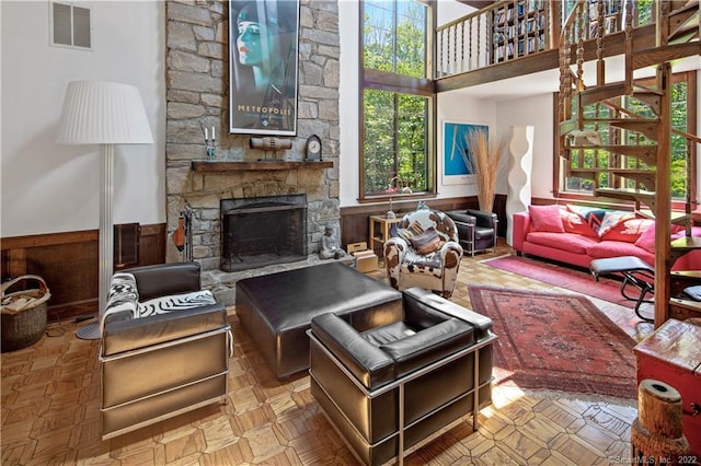 15 Tunxis Trl, Redding, CT 06896 - living area with wainscoting, a stone fireplace, and a towering ceiling