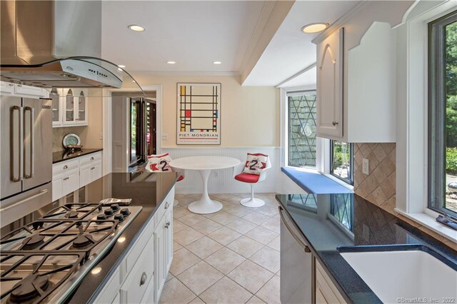 15 Tunxis Trl, Redding, CT 06896 - kitchen featuring island exhaust hood, stainless steel appliances, dark countertops, white cabinets, and wainscoting