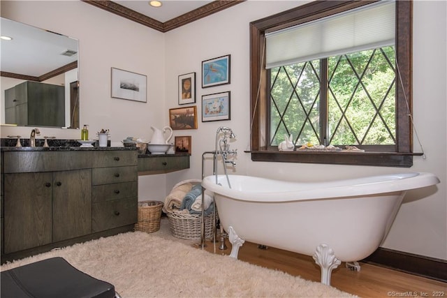 15 Tunxis Trl, Redding, CT 06896 - bathroom featuring wood finished floors, vanity, ornamental molding, a soaking tub, and baseboards