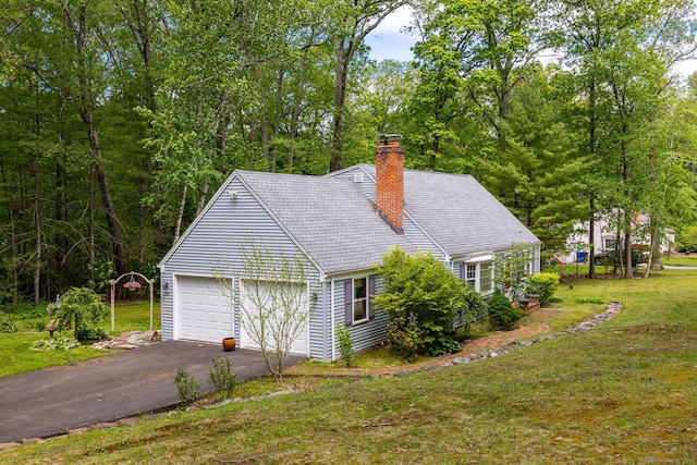 15 Woodcliff Dr, Simsbury, CT 06070 - view of side of property featuring a chimney, asphalt driveway, a yard, and an attached garage