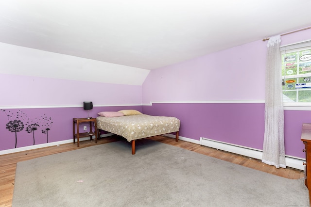 15 Woodcliff Dr, Simsbury, CT 06070 - bedroom with wood finished floors, lofted ceiling, baseboards, and a baseboard radiator