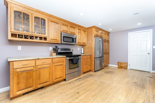 15 Woodcliff Dr, Simsbury, CT 06070 - kitchen featuring appliances with stainless steel finishes, light wood-style floors, baseboards, glass insert cabinets, and recessed lighting