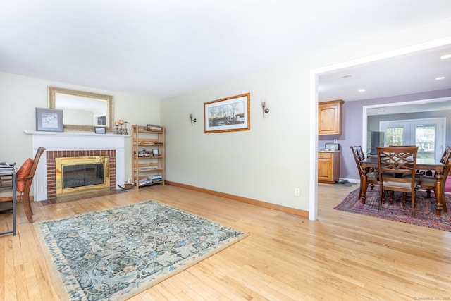15 Woodcliff Dr, Simsbury, CT 06070 - living room with a brick fireplace, light wood-type flooring, baseboards, and recessed lighting
