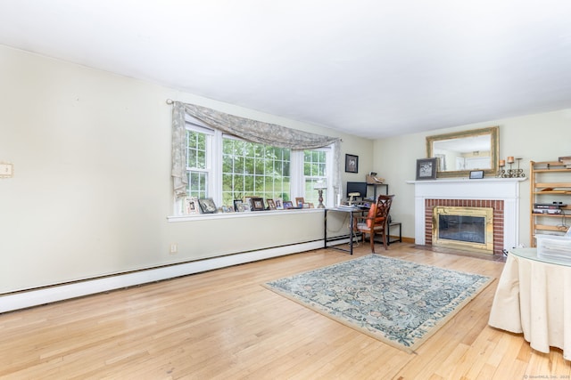 15 Woodcliff Dr, Simsbury, CT 06070 - living area featuring a brick fireplace, wood finished floors, an office area, and a baseboard heating unit