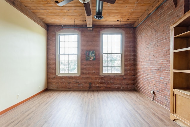 92 Main St Unit 214, Deep River, CT 06417 - spare room with wood finished floors, wood ceiling with exposed beams, ceiling fan, brick wall, and baseboards