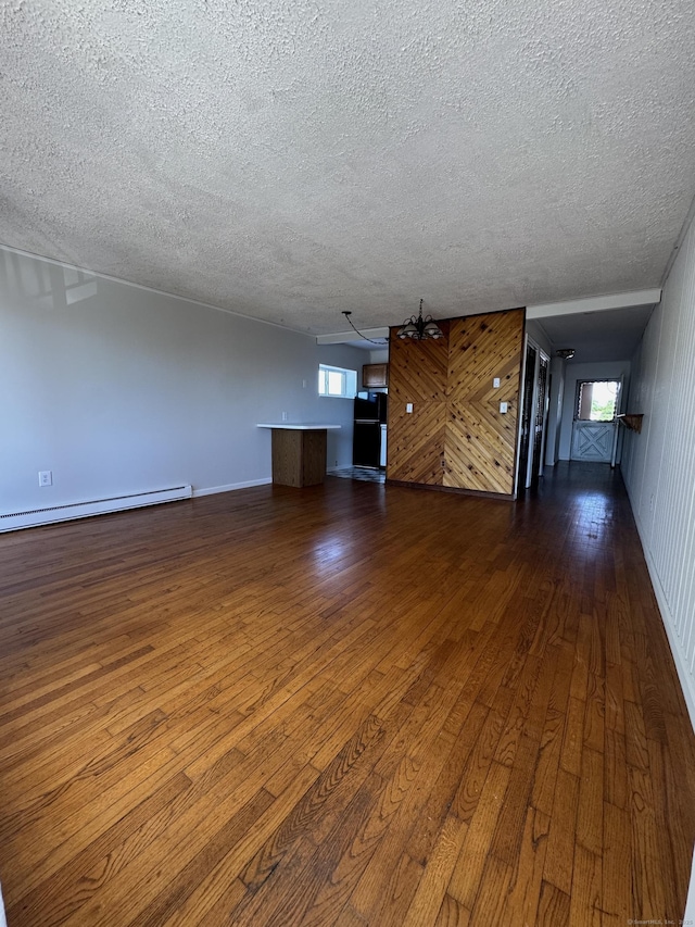 260 W Walk Walk Unit 260, West Haven, CT 06516 - unfurnished living room with a textured ceiling, baseboard heating, dark wood-type flooring, a chandelier, and baseboards