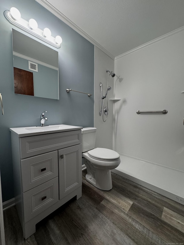 260 W Walk Walk Unit 260, West Haven, CT 06516 - bathroom with wood finished floors, a shower, ornamental molding, toilet, and vanity