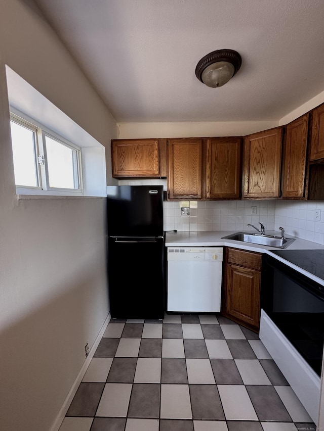 260 W Walk Walk Unit 260, West Haven, CT 06516 - kitchen with dishwasher, freestanding refrigerator, a sink, backsplash, and light countertops