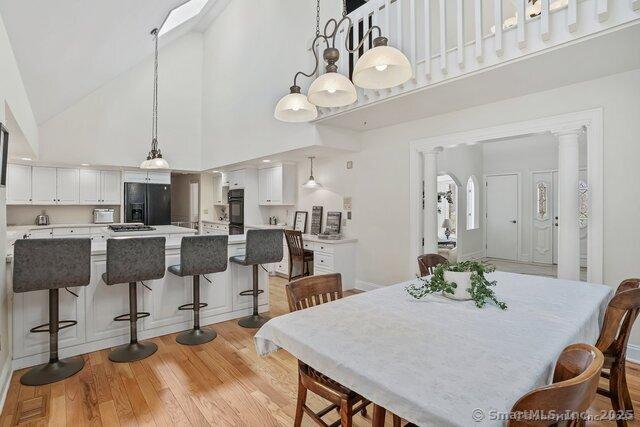 212 Fence Row Dr, Fairfield, CT 06824 - dining space featuring high vaulted ceiling and light wood-style floors