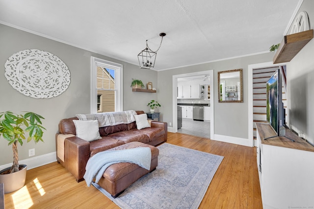 70 Mercer St, Stratford, CT 06614 - living room featuring light wood finished floors, a chandelier, baseboards, and ornamental molding