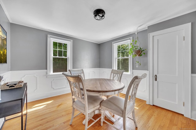 70 Mercer St, Stratford, CT 06614 - dining area with wainscoting, light wood-style flooring, and crown molding