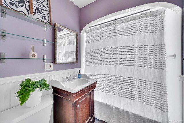 70 Mercer St, Stratford, CT 06614 - bathroom with wainscoting, vanity, toilet, and a shower with shower curtain